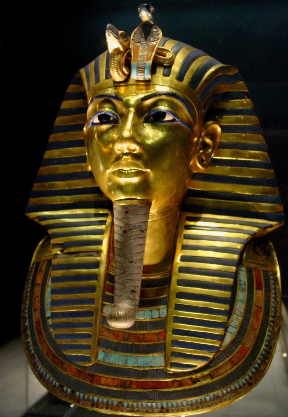 Tutankhamun gold mask under museum glass